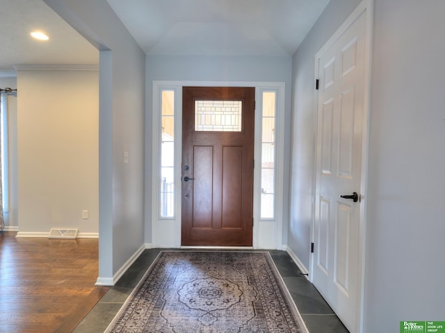 foyer entrance featuring baseboards, visible vents, and dark wood-style flooring