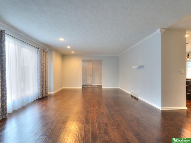 unfurnished living room featuring visible vents, baseboards, dark wood-type flooring, a textured ceiling, and crown molding