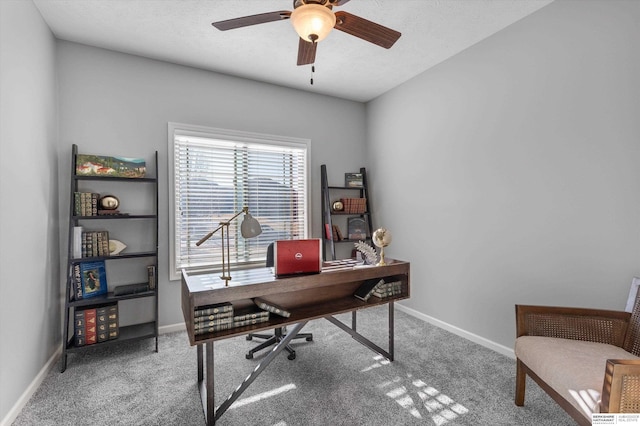 carpeted office space with ceiling fan, a textured ceiling, and baseboards