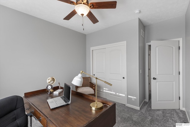 carpeted home office with ceiling fan, visible vents, and baseboards