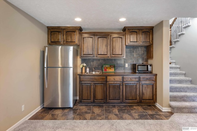 kitchen featuring stainless steel appliances, recessed lighting, dark carpet, decorative backsplash, and baseboards