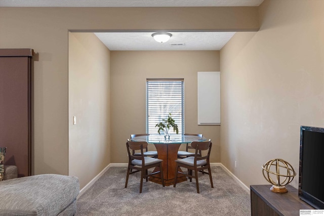 dining area featuring carpet floors, baseboards, and visible vents