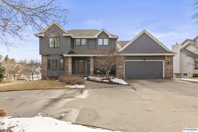 view of front of property with driveway, brick siding, roof with shingles, and an attached garage