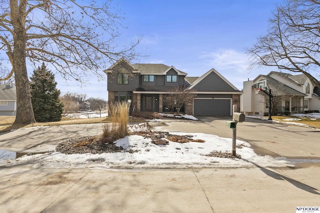 view of front facade with a garage, brick siding, and driveway