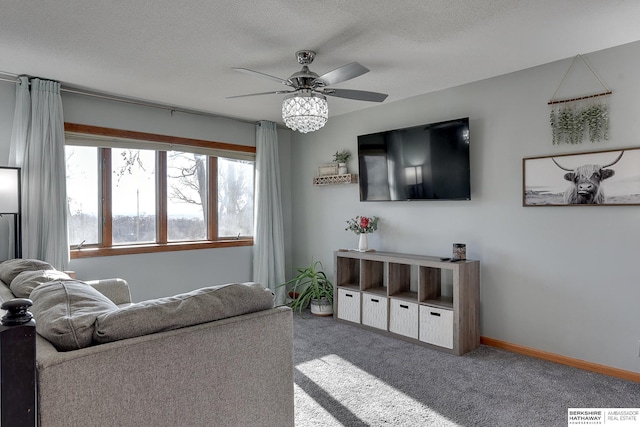 living room with a textured ceiling, visible vents, a ceiling fan, baseboards, and carpet