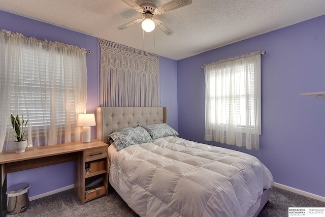 carpeted bedroom featuring a textured ceiling, ceiling fan, and baseboards