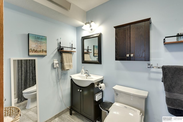 bathroom featuring vanity and toilet