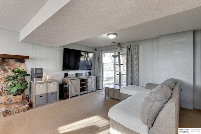 carpeted living room featuring a textured ceiling