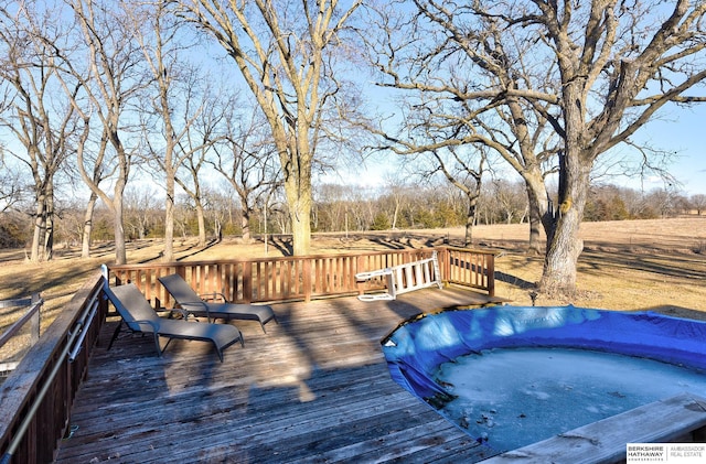 wooden terrace with a hot tub