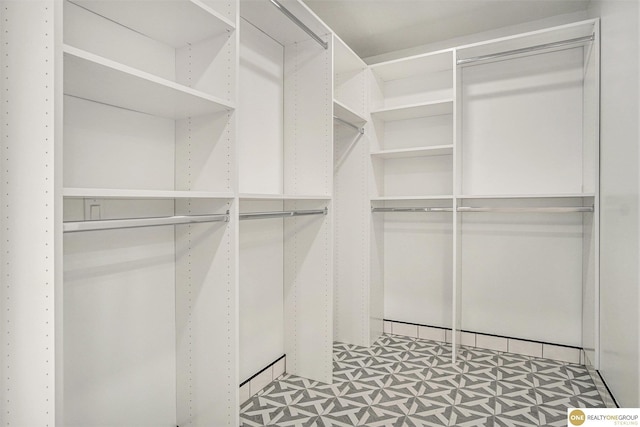 walk in closet featuring light floors