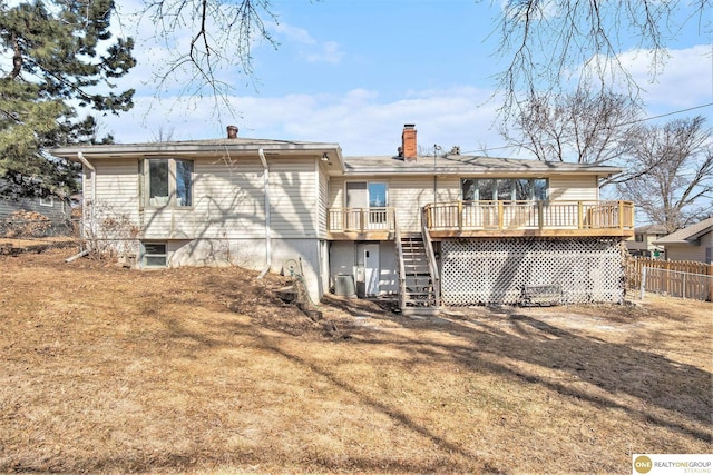 back of property with central AC, fence, stairway, a wooden deck, and a chimney