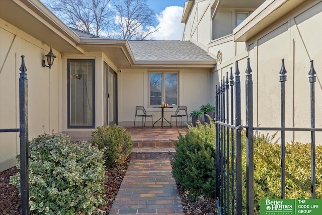 entrance to property with roof with shingles