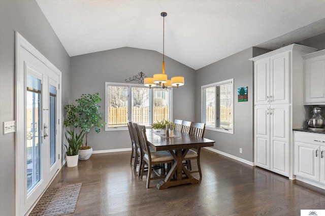 dining space with lofted ceiling, an inviting chandelier, dark wood finished floors, and baseboards