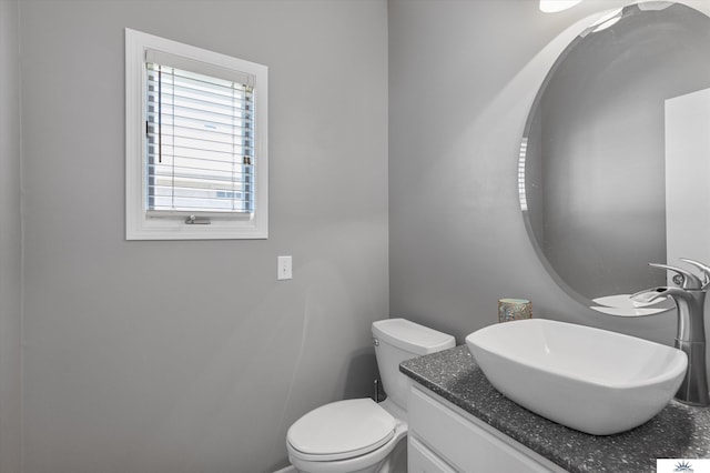 bathroom featuring toilet and vanity