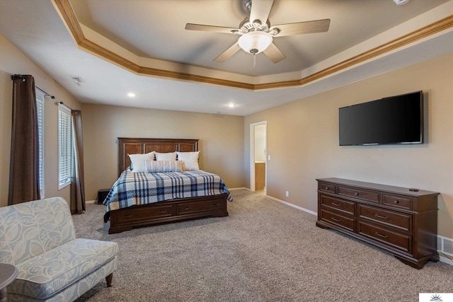 bedroom with light carpet, a tray ceiling, visible vents, and baseboards