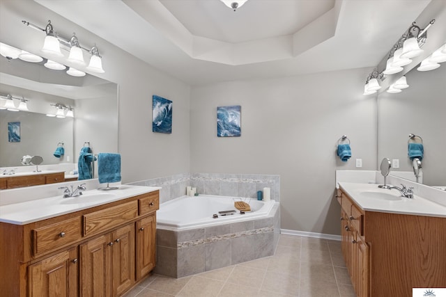 bathroom with tile patterned flooring, a raised ceiling, two vanities, and a sink