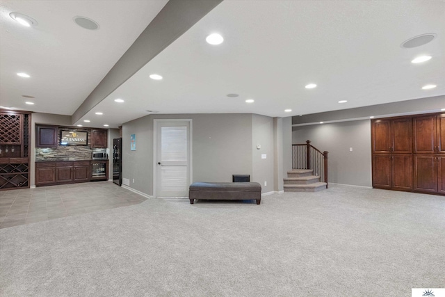 interior space featuring light carpet, stairs, a bar, and recessed lighting