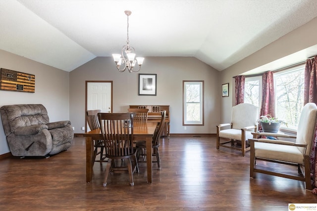 dining area featuring a chandelier, vaulted ceiling, and wood finished floors