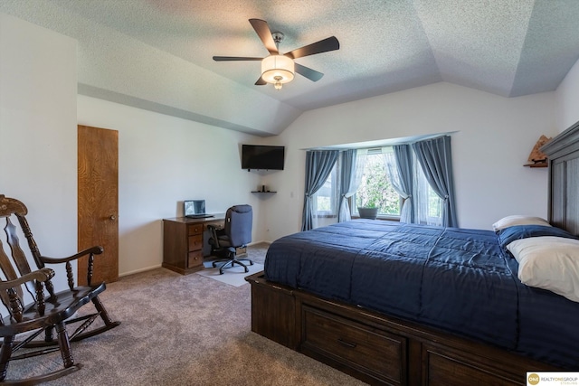 bedroom featuring vaulted ceiling, a textured ceiling, carpet flooring, and a ceiling fan