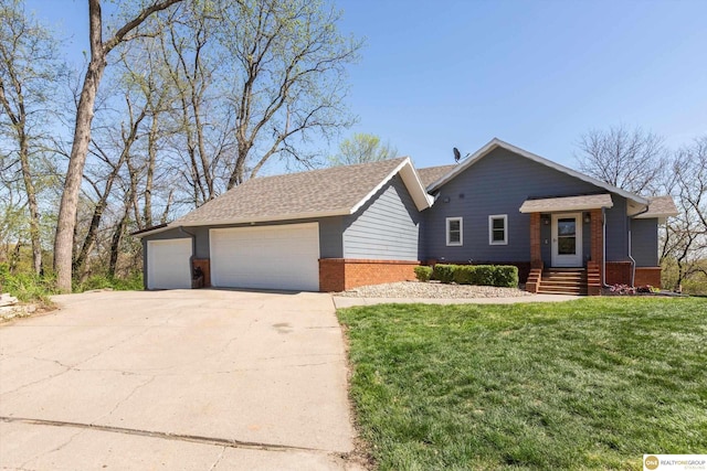 ranch-style house featuring a garage, a front yard, and brick siding