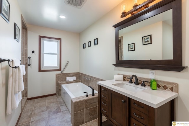 full bathroom featuring baseboards, visible vents, a tile shower, vanity, and a bath