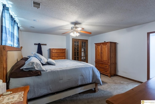 bedroom with visible vents, a ceiling fan, light carpet, a textured ceiling, and baseboards