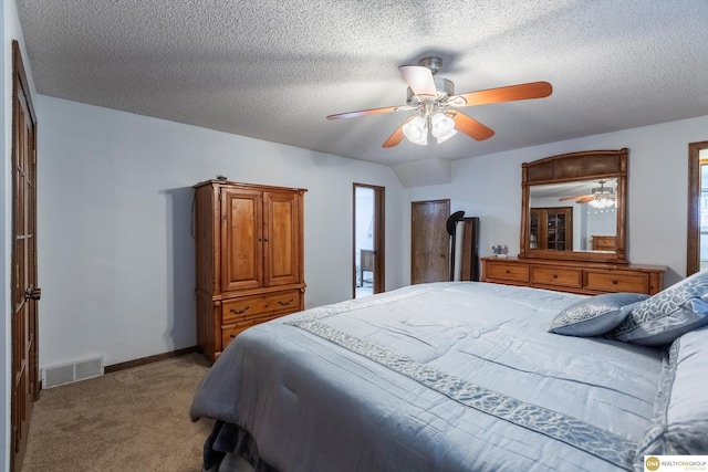 carpeted bedroom featuring visible vents, ceiling fan, a textured ceiling, and baseboards