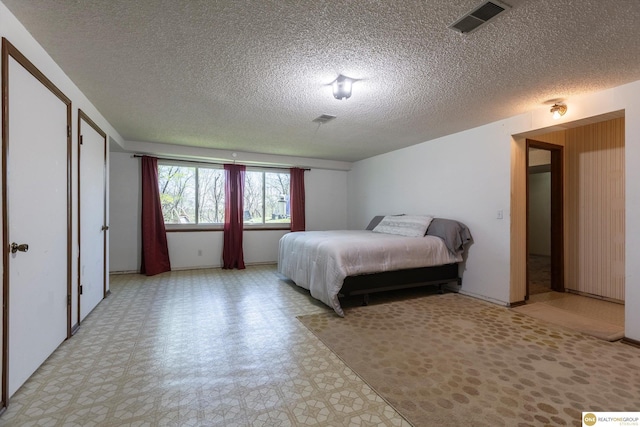 bedroom with light floors and visible vents