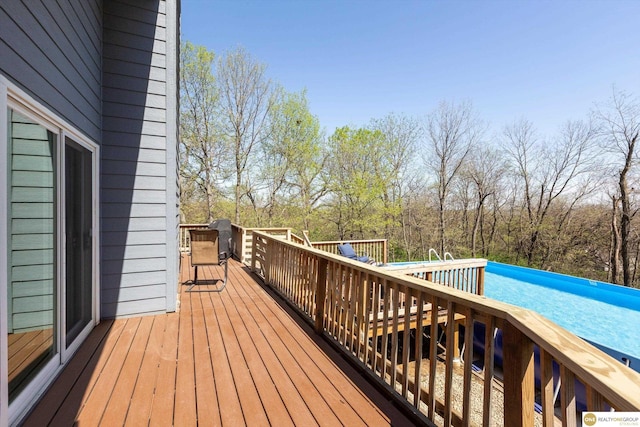 deck featuring an outdoor pool