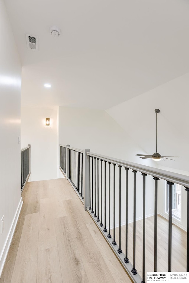 hallway featuring visible vents and light wood-style floors