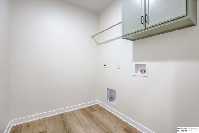 laundry room featuring cabinet space, baseboards, light wood-style flooring, hookup for a washing machine, and hookup for an electric dryer