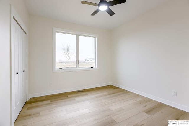 unfurnished bedroom with visible vents, baseboards, ceiling fan, light wood-style floors, and a closet