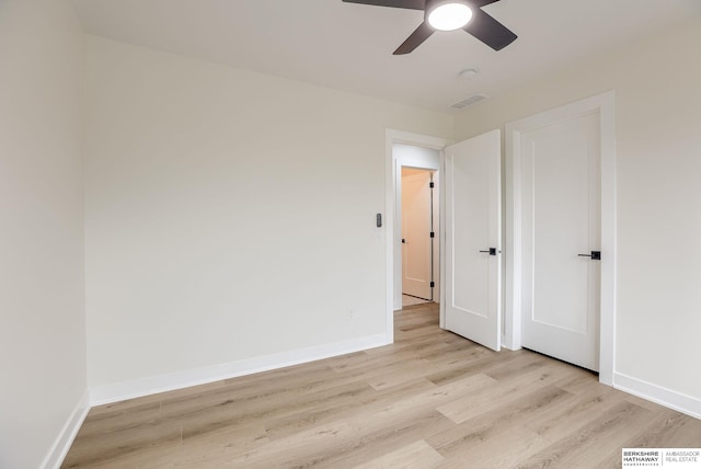 unfurnished bedroom with ceiling fan, light wood finished floors, visible vents, and baseboards