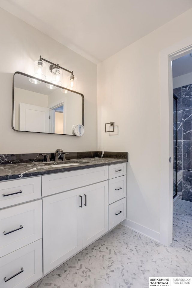 bathroom featuring vanity and baseboards