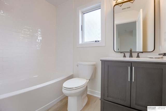 bathroom featuring toilet, wood finished floors, visible vents, vanity, and baseboards