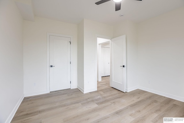 unfurnished bedroom with a ceiling fan, baseboards, and light wood finished floors