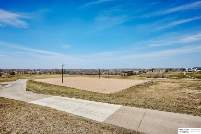 surrounding community with a yard and volleyball court