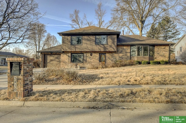 view of front of home featuring a garage and brick siding