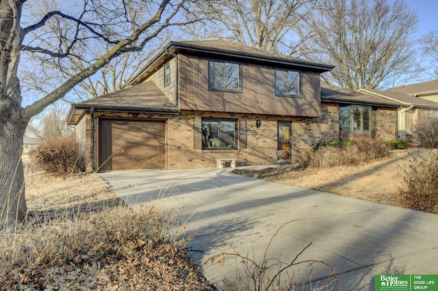 view of front of property with brick siding, a garage, and driveway