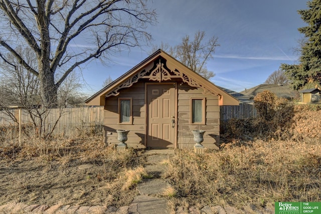 view of outbuilding with an outbuilding and fence