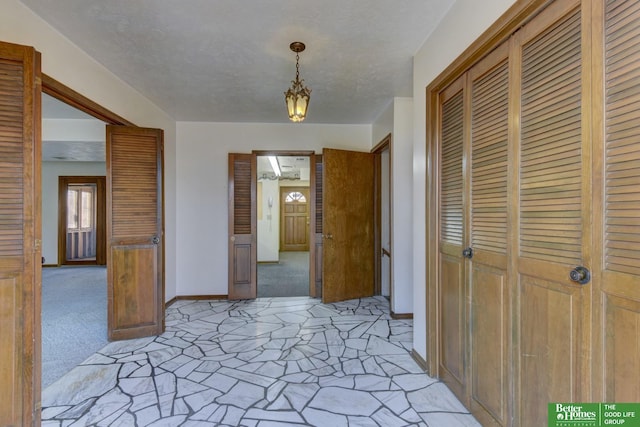 unfurnished dining area with light carpet and baseboards