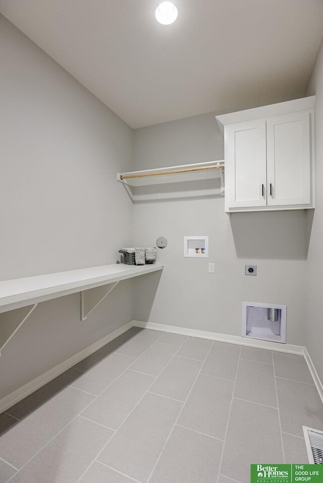 laundry area with light tile patterned floors, washer hookup, visible vents, baseboards, and electric dryer hookup