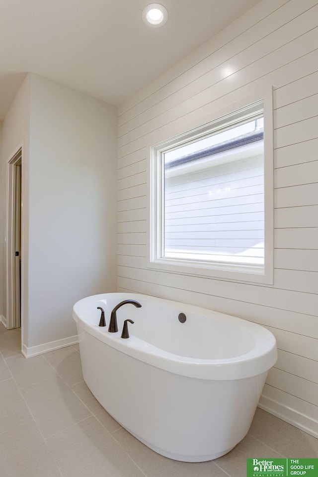 bathroom featuring recessed lighting, a freestanding bath, baseboards, and tile patterned floors