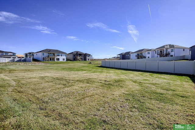 view of yard with fence and a residential view