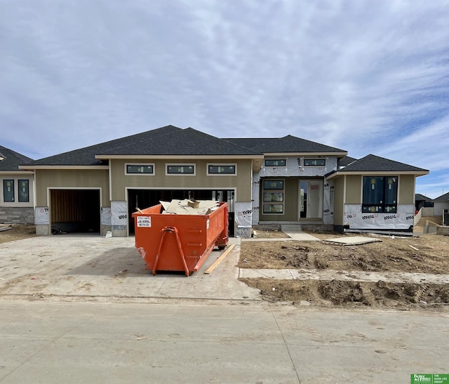 property under construction with a garage and stucco siding