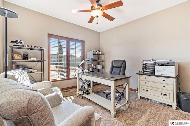 home office with ceiling fan, baseboards, and light colored carpet