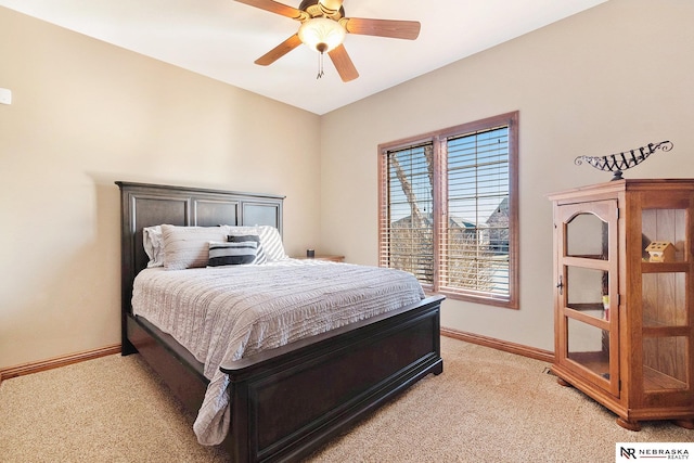 bedroom featuring light carpet, a ceiling fan, and baseboards