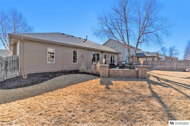 back of house with a yard, fence, and a patio