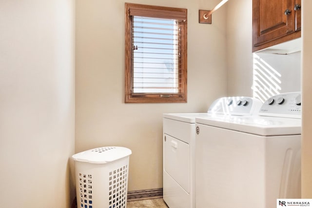 washroom featuring cabinet space and independent washer and dryer