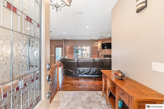 foyer entrance featuring a fireplace and recessed lighting